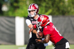 IU football quarterback Fernando Mendoza hands the ball off at fall camp.