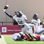 An Old Dominion football player attempts to catch a pass.