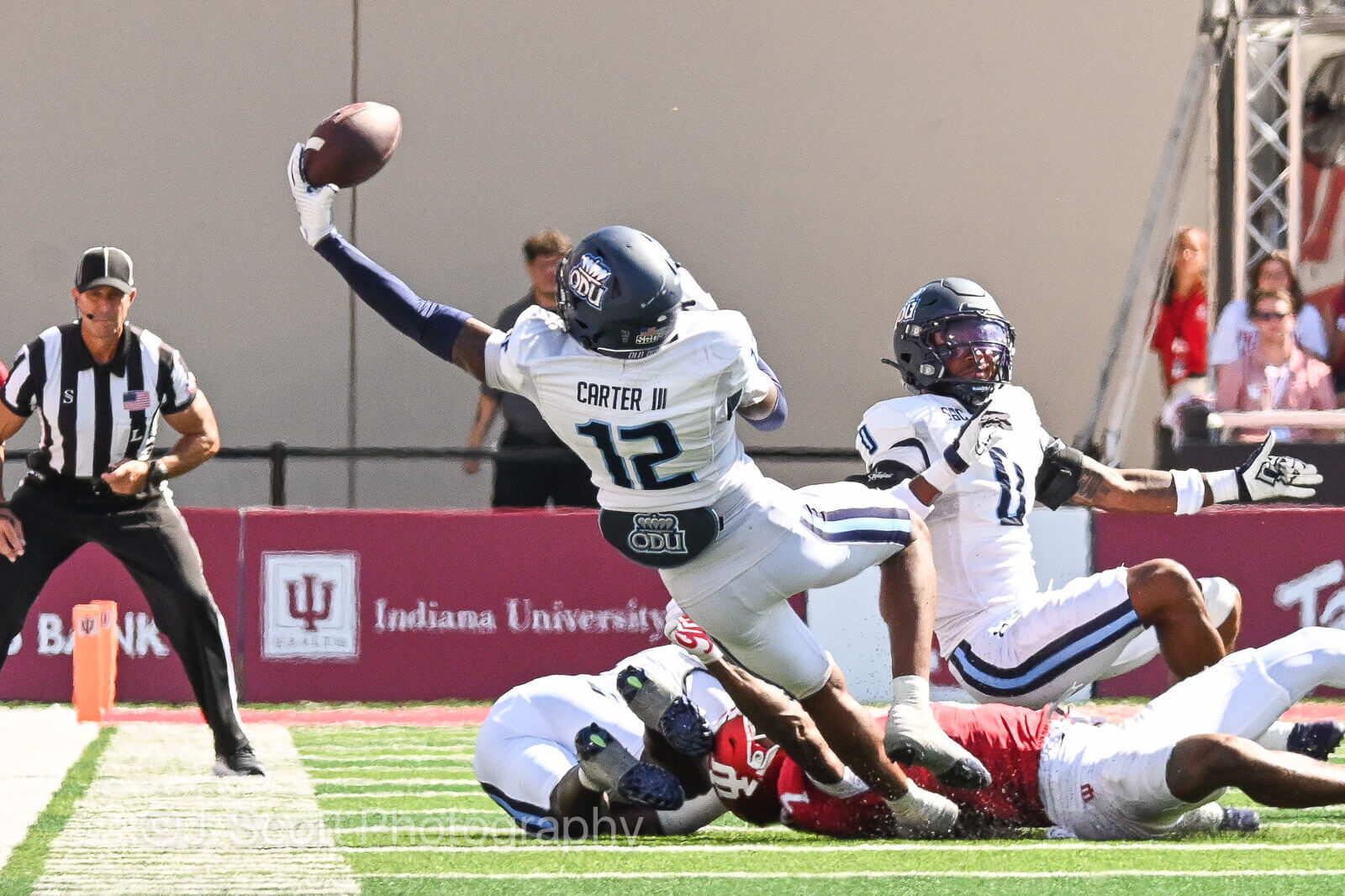 An Old Dominion football player attempts to catch a pass.