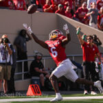 IU football player attempts to catch the ball.
