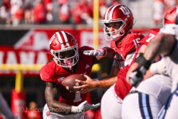 IU football quarterback Fernando Mendoza hands off the ball.