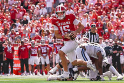 IU quarterback Fernando Mendoza scrambles away from a defender.