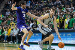 Oregon's Nate Bittle puts the ball on the floor.