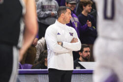 Washington coach Danny Sprinkle stands on the sidelines.