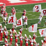 IU players and cheerleaders run onto the field at Memorial Stadium.