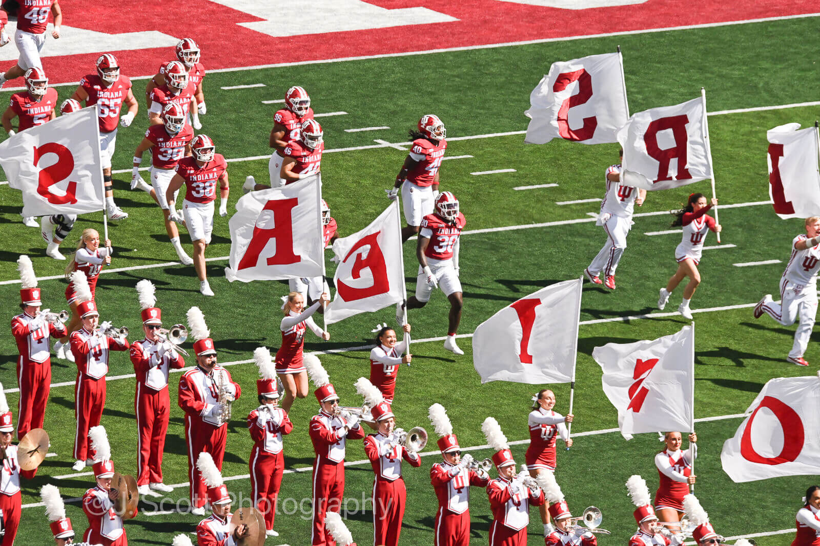 IU players and cheerleaders run onto the field at Memorial Stadium.