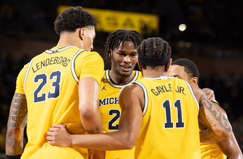 Michigan basketball huddles.