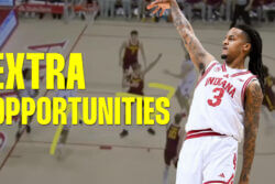 Lamar Wilkerson watches his shot with his arm raised.