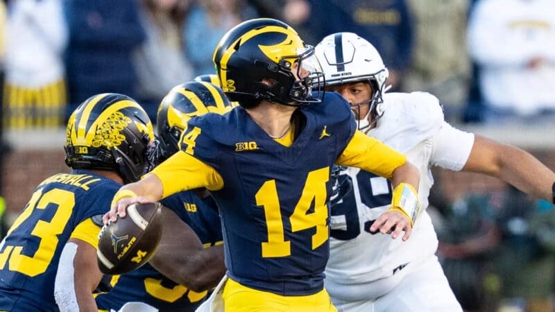 Michigan quarterback Tommy Carr attempts a pass against Penn State.